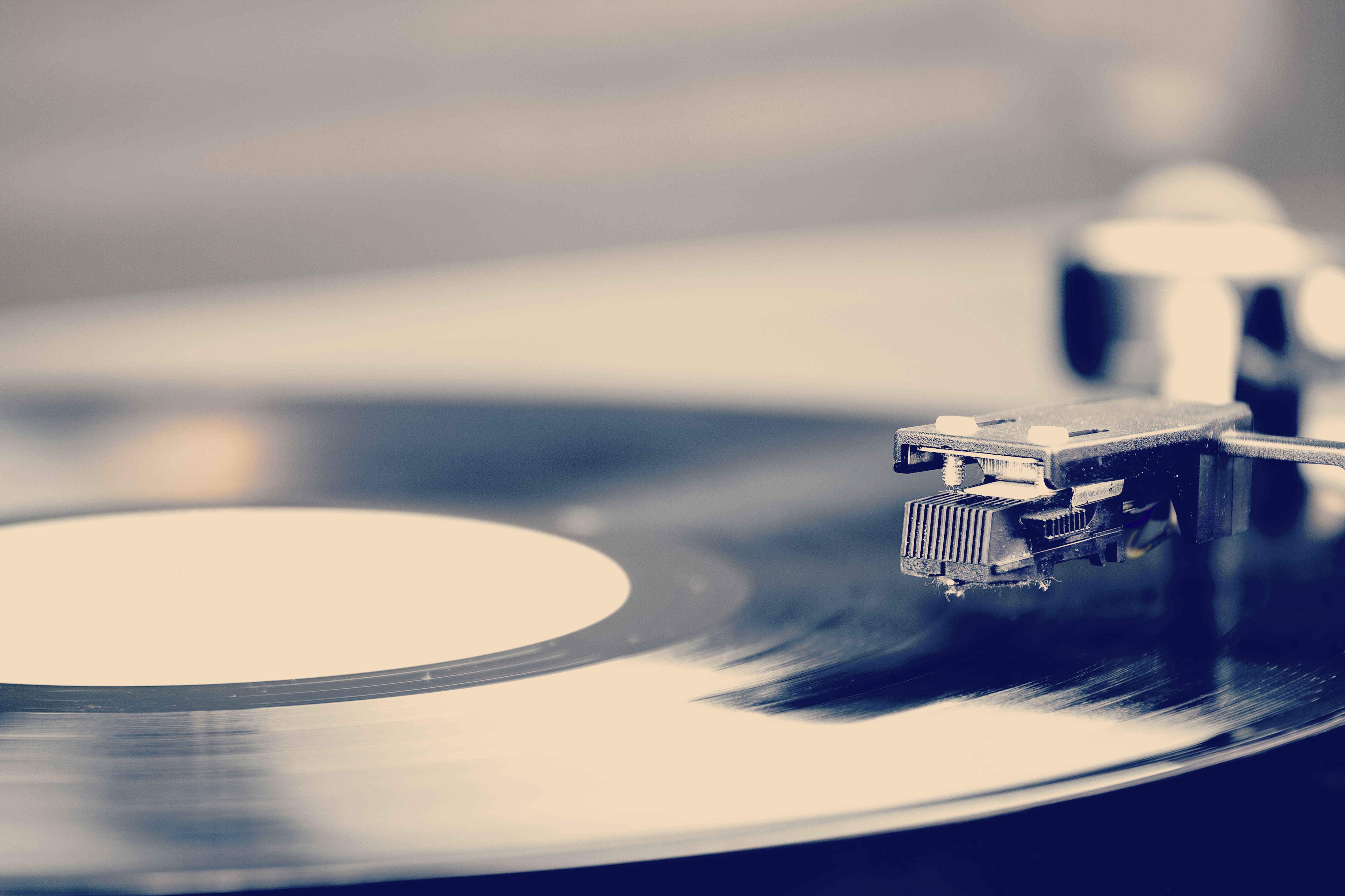 Spinning vinyl record. Motion blur image. Vintage toned.
