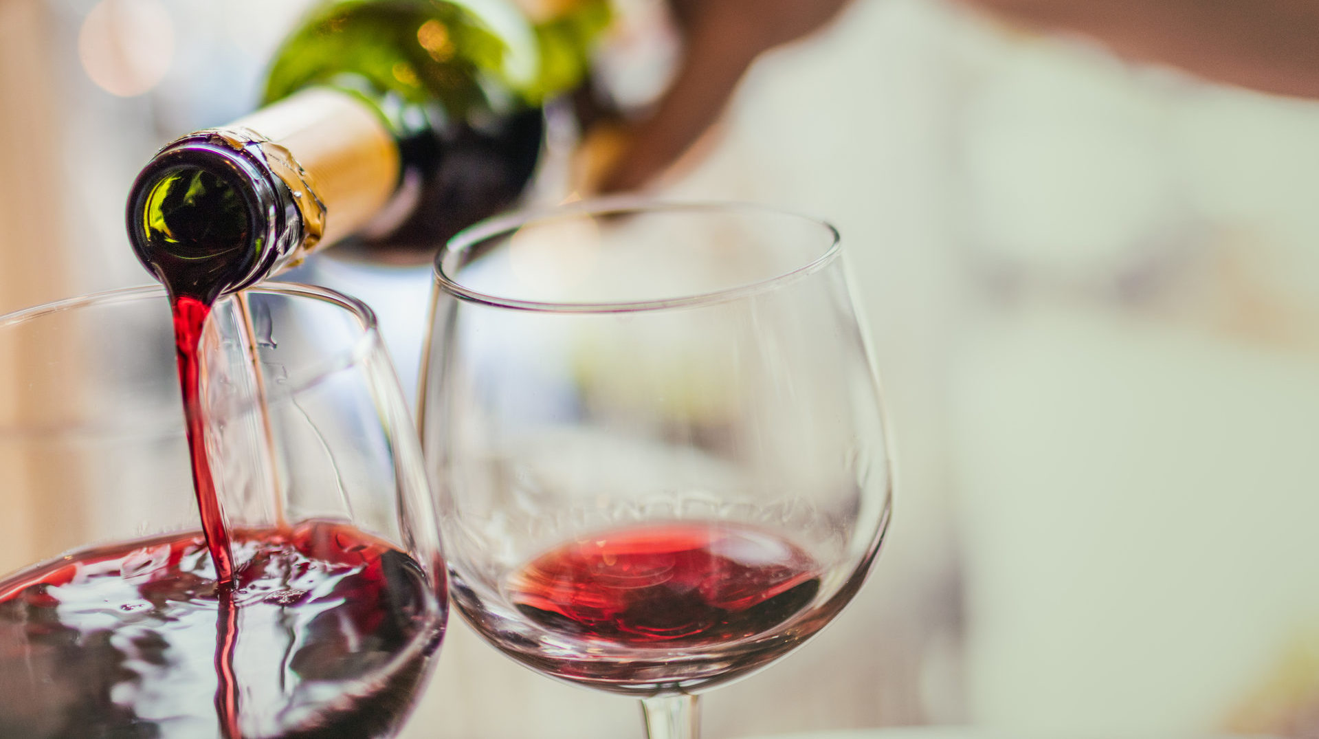 Pouring red wine in glasses