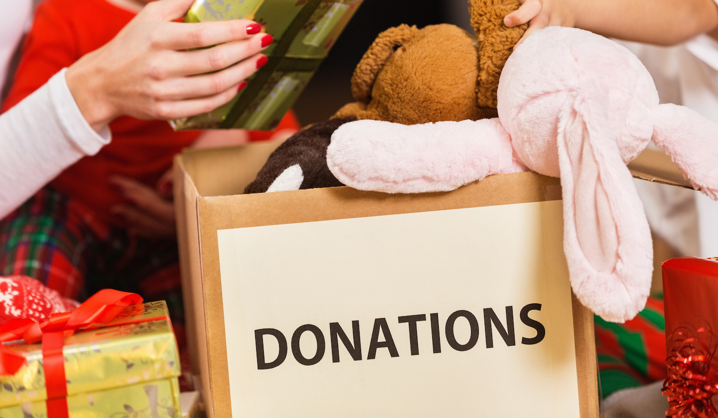 Family donating gifts and toys to charity for Christmas holiday