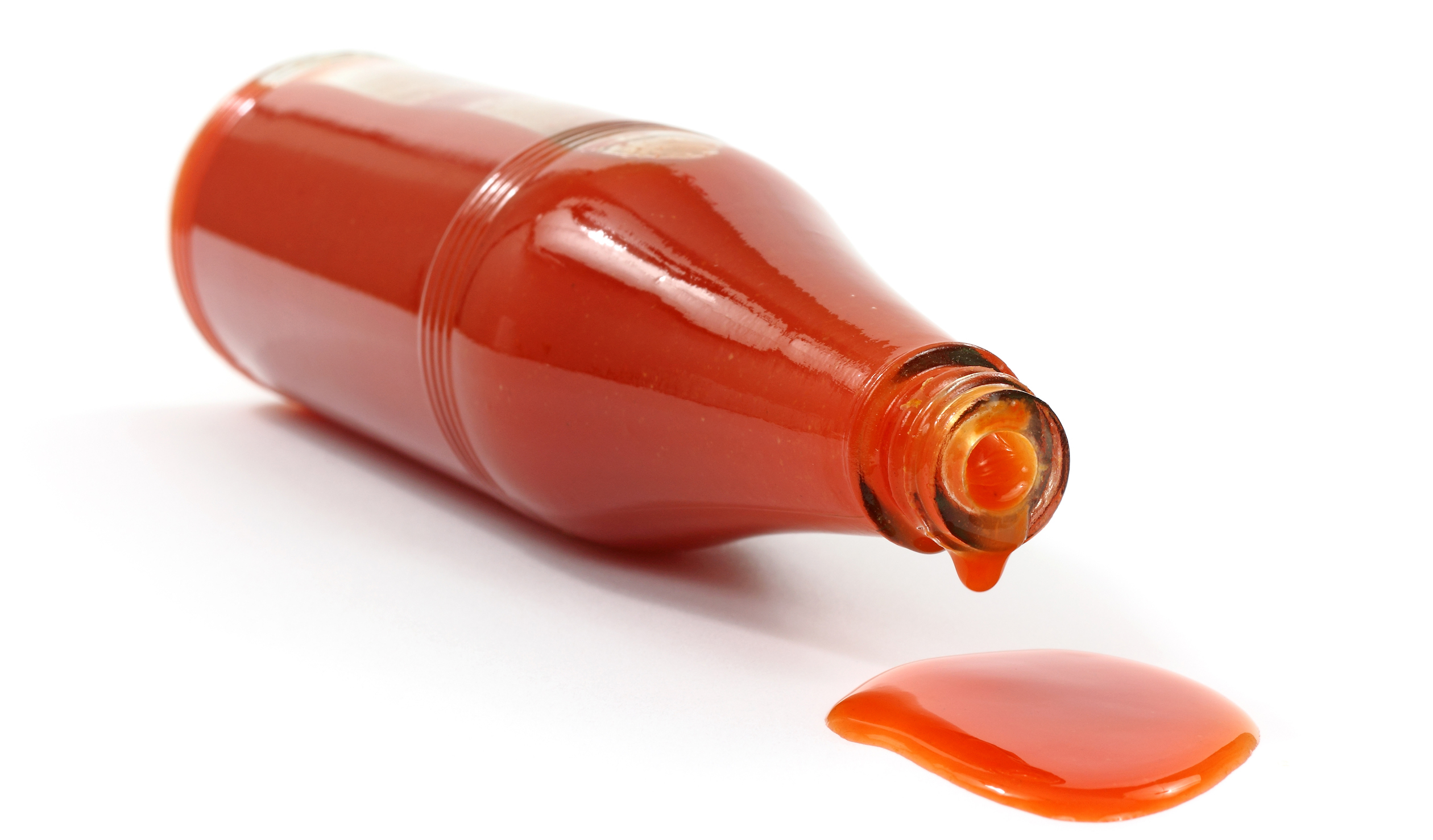 Hot sauce spilling from bottle