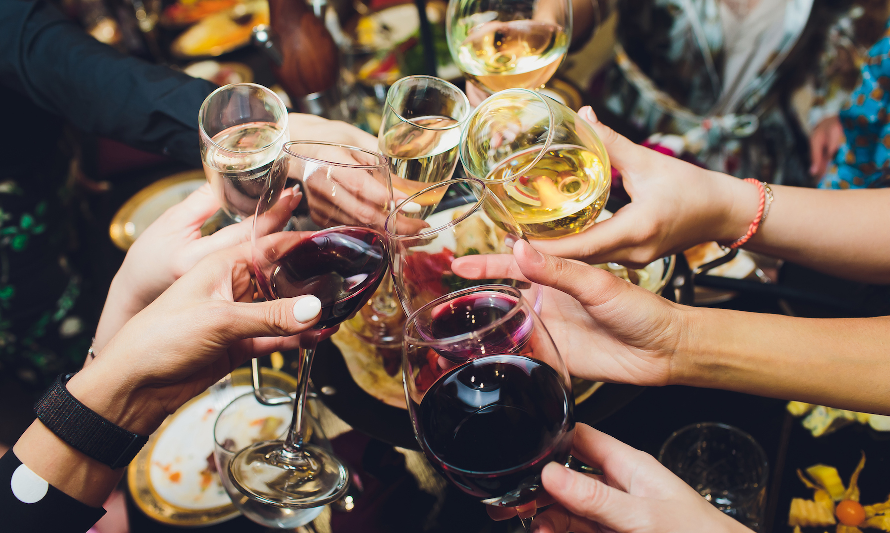 Champagne glasses in hands of people at party.
