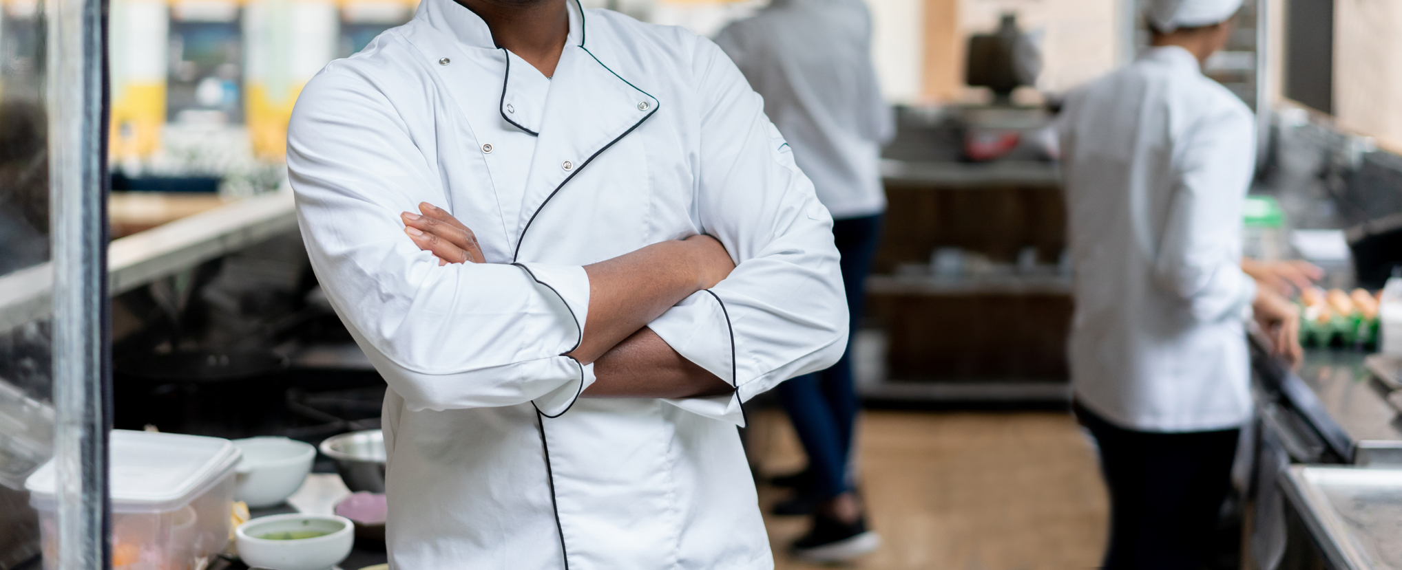 Happy chef working in a kitchen at a restaurant