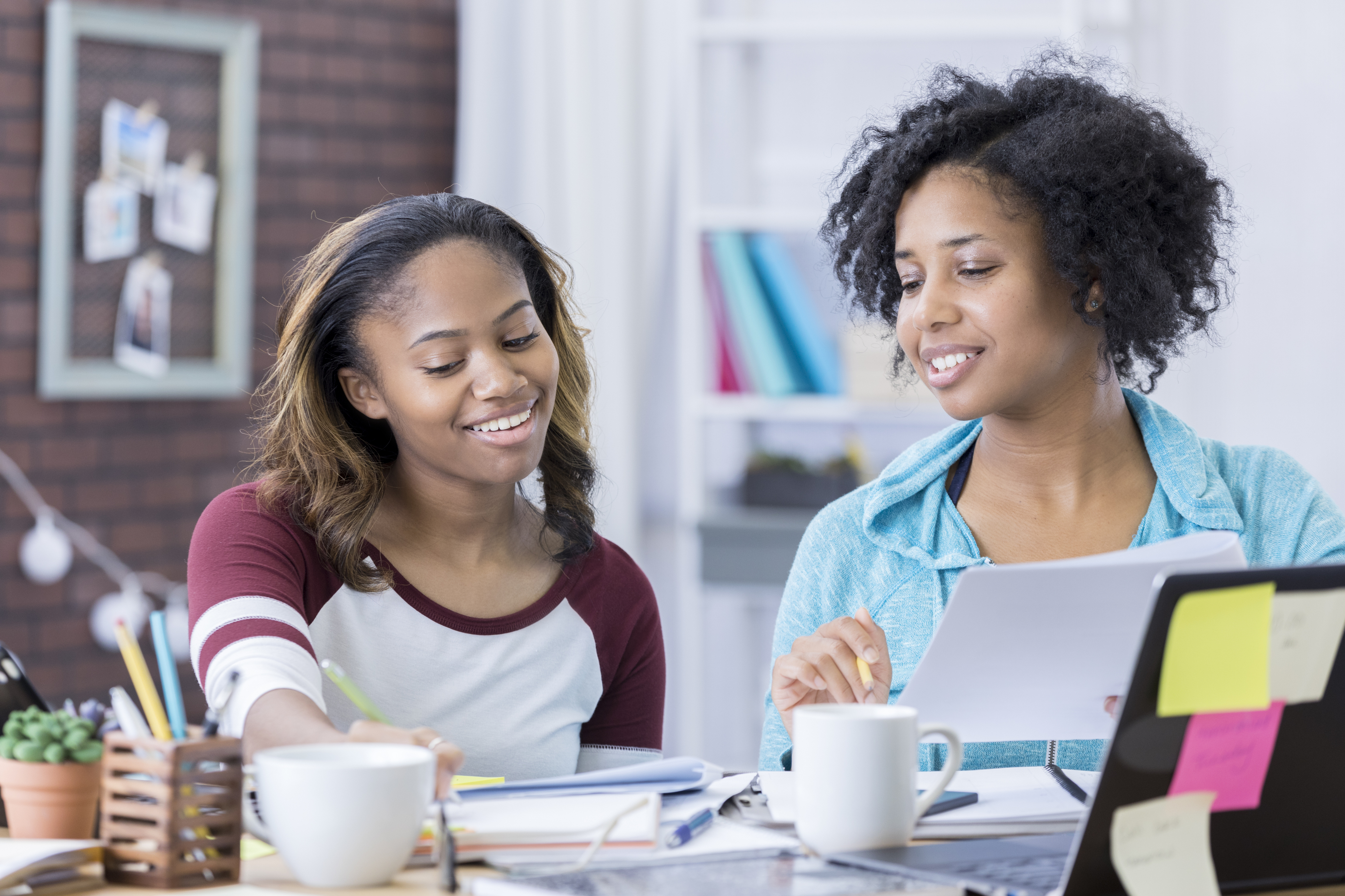 Mom helps teenage daughter with homework